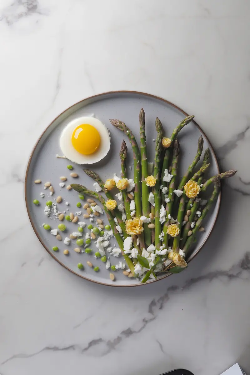 Creative asparagus art plating with fried egg