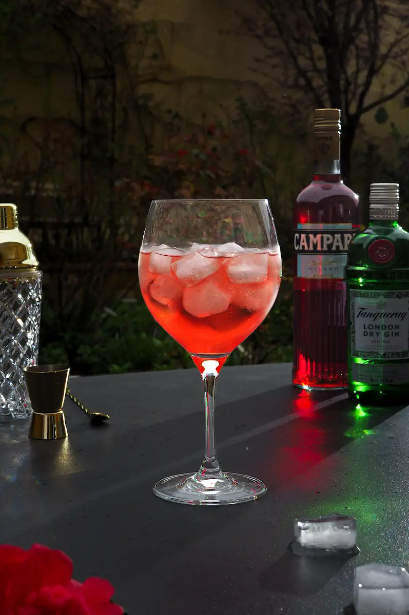 A refreshing red Campari and gin cocktail in a balloon glass