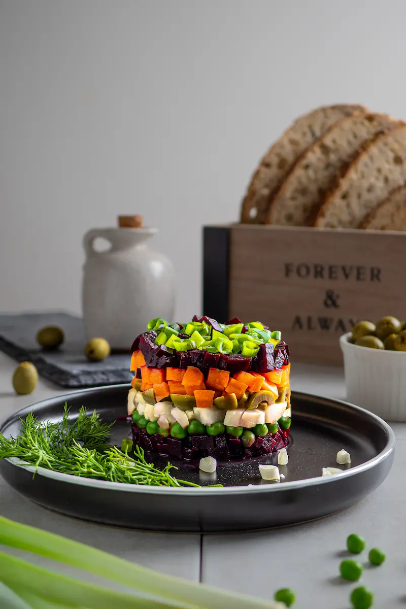 Layered vegetable salad tower with beetroot and carrots