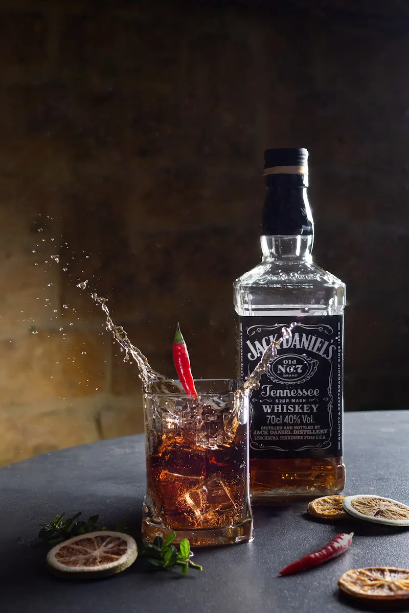 Jack Daniel's whiskey splash with a chili pepper garnish